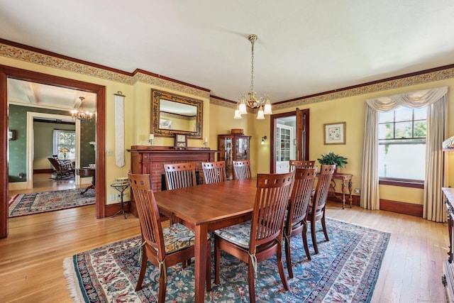 222 N Beacon St, Hartford, CT 06105 - dining area with a chandelier, plenty of natural light, light wood finished floors, baseboards, and crown molding