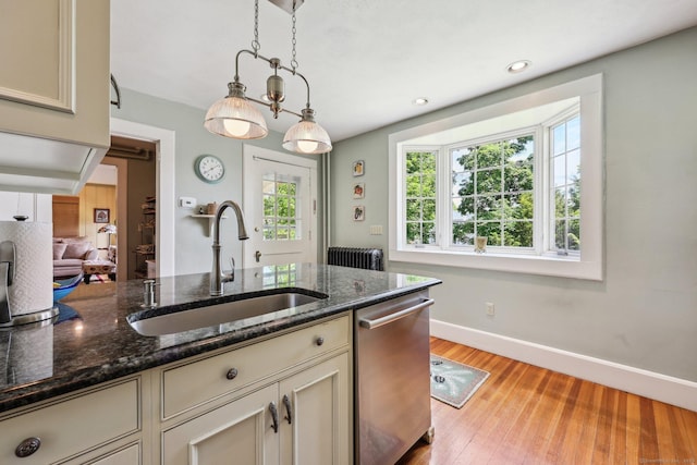 222 N Beacon St, Hartford, CT 06105 - kitchen featuring stainless steel dishwasher, a sink, baseboards, radiator heating unit, and hanging light fixtures