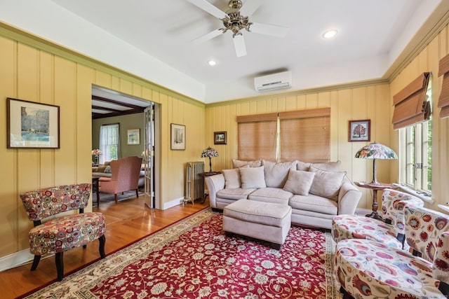 222 N Beacon St, Hartford, CT 06105 - living area with a wall mounted air conditioner, healthy amount of natural light, radiator, wood finished floors, and recessed lighting