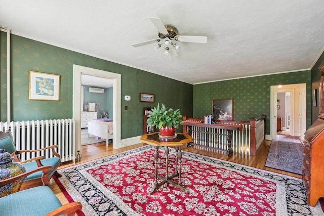 222 N Beacon St, Hartford, CT 06105 - living area with radiator heating unit, wood finished floors, a ceiling fan, ornamental molding, and an AC wall unit