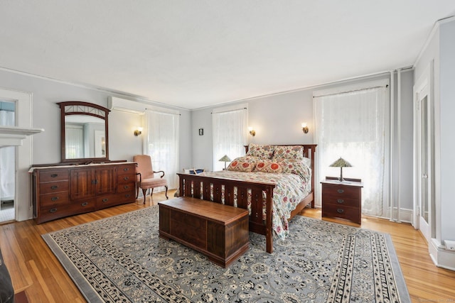 222 N Beacon St, Hartford, CT 06105 - bedroom featuring a wall unit AC, wood finished floors, and crown molding