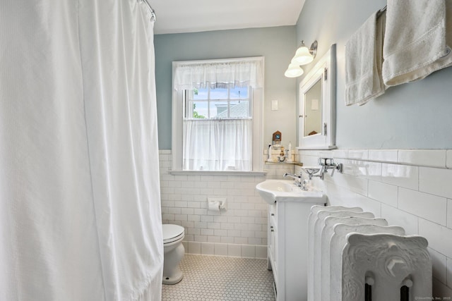 222 N Beacon St, Hartford, CT 06105 - full bathroom with tile walls, tile patterned flooring, vanity, toilet, and wainscoting