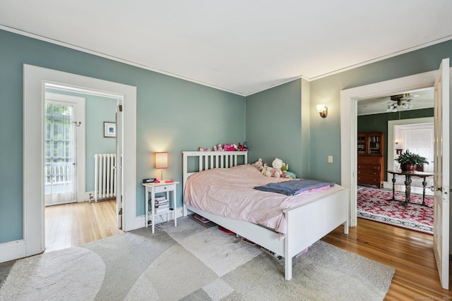 222 N Beacon St, Hartford, CT 06105 - bedroom with radiator heating unit, wood finished floors, and ornamental molding