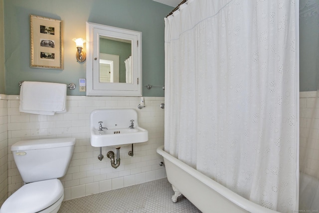222 N Beacon St, Hartford, CT 06105 - full bathroom with tile walls, toilet, a wainscoted wall, tile patterned floors, and a sink