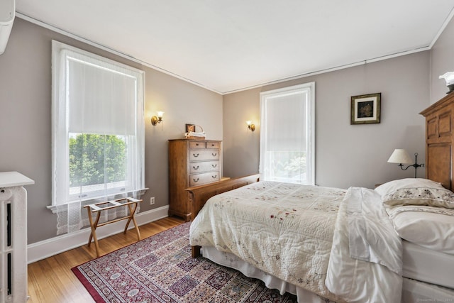 222 N Beacon St, Hartford, CT 06105 - bedroom with light wood-type flooring, crown molding, and baseboards