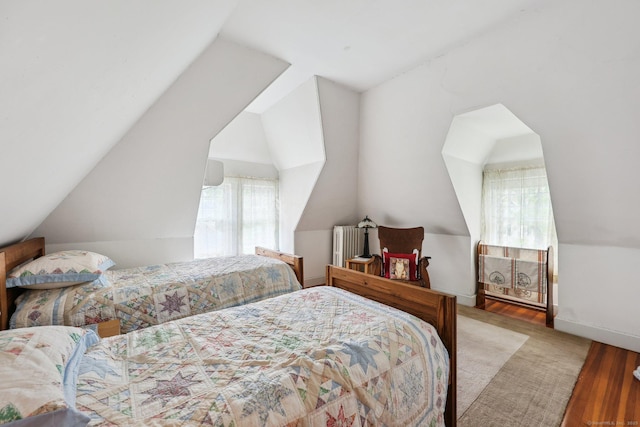 222 N Beacon St, Hartford, CT 06105 - bedroom featuring wood finished floors, vaulted ceiling, radiator, and baseboards