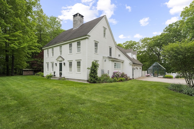 7 Shelter Rock Rd, East Haddam, CT 06423 - view of side of home featuring driveway, a yard, a chimney, a garage, and a shingled roof