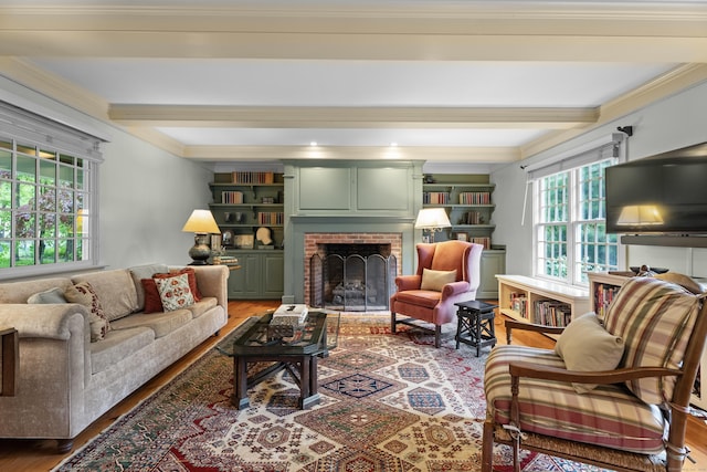 7 Shelter Rock Rd, East Haddam, CT 06423 - living area featuring light wood finished floors, beam ceiling, a brick fireplace, and ornamental molding