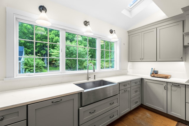 7 Shelter Rock Rd, East Haddam, CT 06423 - kitchen with gray cabinetry, a sink, a skylight, and lofted ceiling