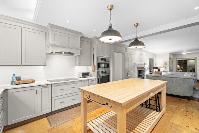 7 Shelter Rock Rd, East Haddam, CT 06423 - kitchen featuring double oven, light countertops, pendant lighting, black electric cooktop, and gray cabinets