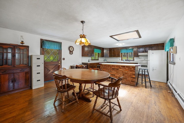 205 Allentown Rd, Plymouth, CT 06786 - dining area with hardwood / wood-style flooring, a textured ceiling, a baseboard heating unit, and healthy amount of natural light