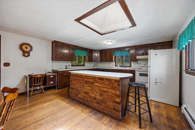 205 Allentown Rd, Plymouth, CT 06786 - kitchen with a baseboard radiator, white appliances, a skylight, a center island, and light countertops
