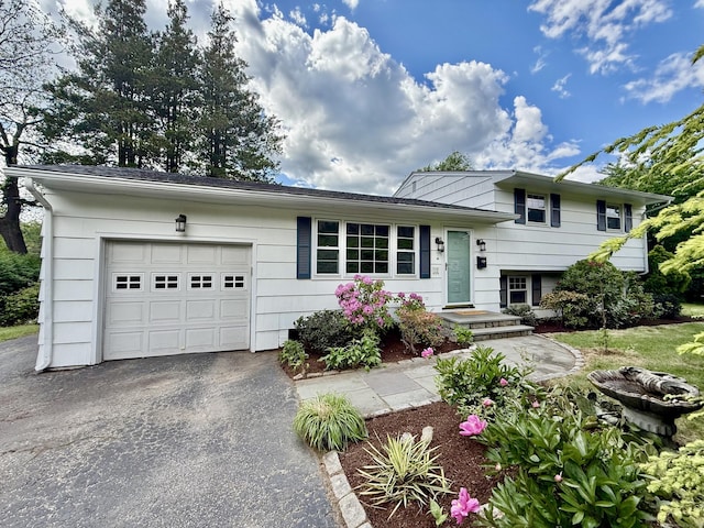 12 Sugar Plum Ln, Fairfield, CT 06824 - split level home featuring asphalt driveway and an attached garage