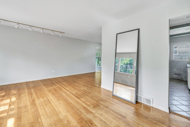 12 Sugar Plum Ln, Fairfield, CT 06824 - unfurnished room featuring rail lighting, light wood-style flooring, and baseboards
