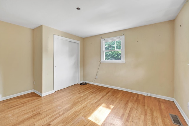 12 Sugar Plum Ln, Fairfield, CT 06824 - unfurnished bedroom with light wood-style floors, baseboards, and a closet