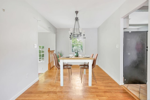 12 Sugar Plum Ln, Fairfield, CT 06824 - dining area with plenty of natural light, a chandelier, light wood finished floors, and baseboards