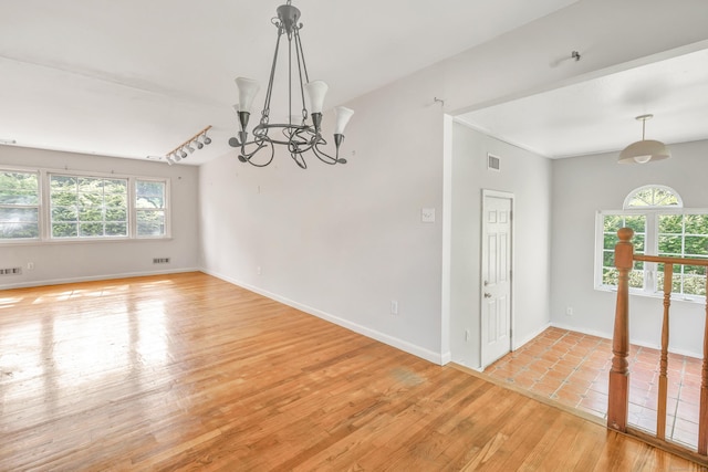 12 Sugar Plum Ln, Fairfield, CT 06824 - unfurnished room with a chandelier, light wood-type flooring, and baseboards