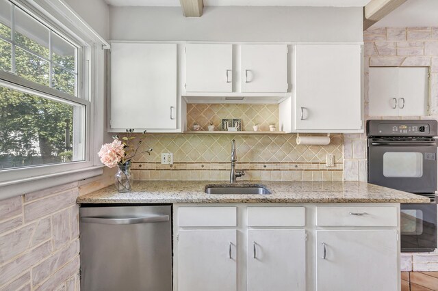 12 Sugar Plum Ln, Fairfield, CT 06824 - kitchen with stainless steel dishwasher, a sink, white cabinets, and plenty of natural light