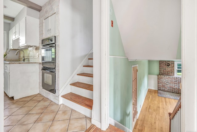 12 Sugar Plum Ln, Fairfield, CT 06824 - staircase featuring tile patterned floors and lofted ceiling