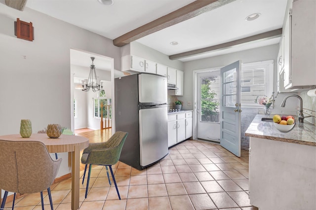 12 Sugar Plum Ln, Fairfield, CT 06824 - kitchen with freestanding refrigerator, a sink, beam ceiling, white cabinetry, and light tile patterned floors