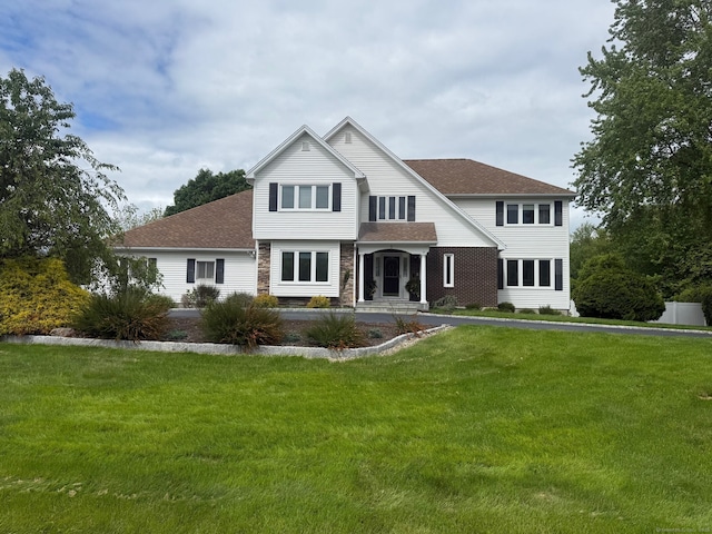 3 Colman Dr, Wolcott, CT 06716 - traditional-style home with roof with shingles, a front lawn, and stone siding