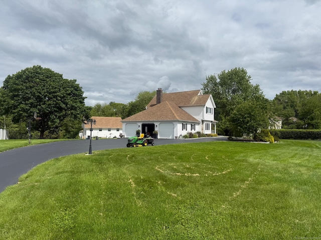 3 Colman Dr, Wolcott, CT 06716 - view of front facade featuring a garage, driveway, a front yard, and a chimney