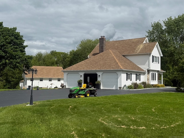 3 Colman Dr, Wolcott, CT 06716 - view of front facade with an attached garage, a front yard, driveway, a chimney, and a shingled roof