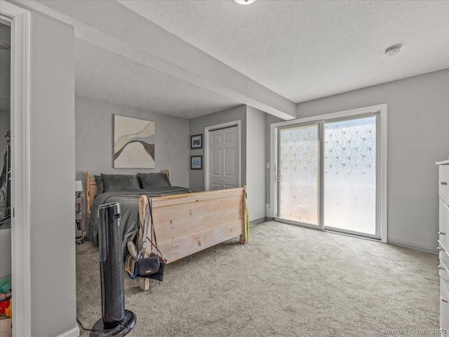 3 Colman Dr, Wolcott, CT 06716 - carpeted bedroom featuring access to exterior, a textured ceiling, and baseboards