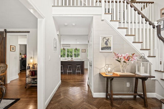 168 Fern Ave, Litchfield, CT 06759 - foyer featuring baseboards, washer / dryer, stairs, and a barn door