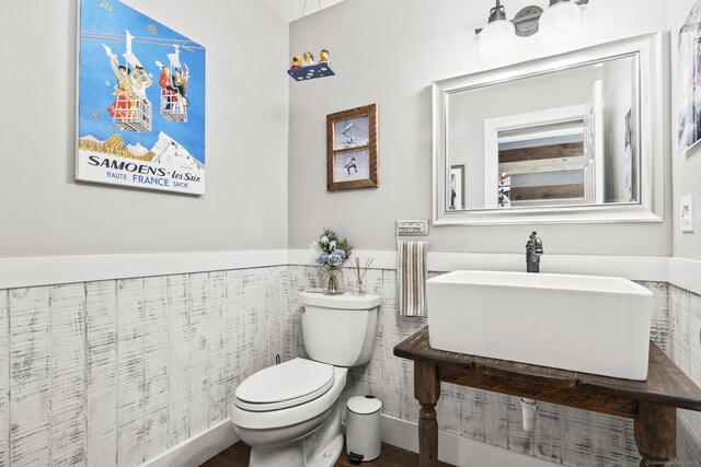 168 Fern Ave, Litchfield, CT 06759 - bathroom with toilet, a sink, a wainscoted wall, and tile walls