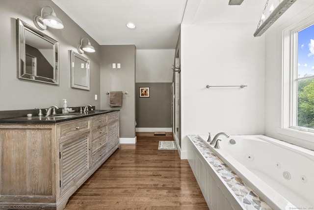 168 Fern Ave, Litchfield, CT 06759 - full bathroom with wood finished floors, double vanity, a tub with jets, and baseboards