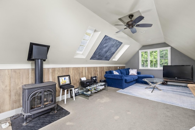 168 Fern Ave, Litchfield, CT 06759 - carpeted living room with lofted ceiling, a wood stove, wood walls, and ceiling fan