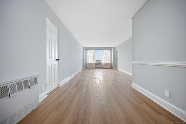 71 Strawberry Hill Ave Unit 710, Stamford, CT 06902 - spare room with light wood-style floors and radiator heating unit