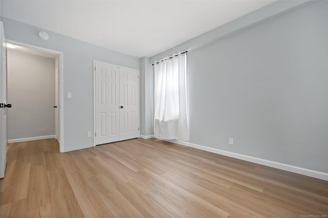 71 Strawberry Hill Ave Unit 710, Stamford, CT 06902 - unfurnished bedroom with light wood-style flooring and a closet