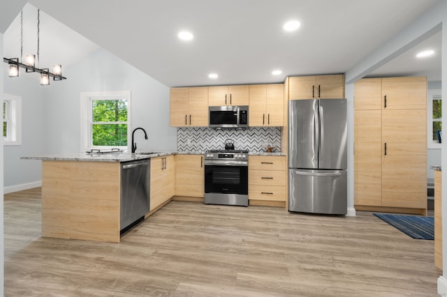 19 Old Acres Rd, East Haddam, CT 06469 - kitchen with stainless steel appliances, light brown cabinetry, a peninsula, light stone countertops, and light wood-style flooring
