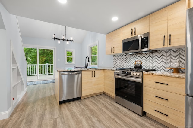 19 Old Acres Rd, East Haddam, CT 06469 - kitchen with stainless steel appliances, light brown cabinets, a sink, light wood-type flooring, and a peninsula