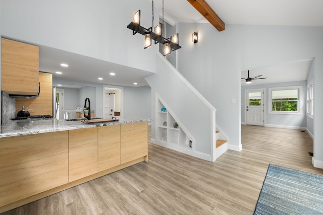 19 Old Acres Rd, East Haddam, CT 06469 - kitchen with high vaulted ceiling, light brown cabinets, light stone countertops, light wood-style flooring, and a peninsula