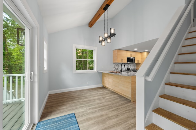 19 Old Acres Rd, East Haddam, CT 06469 - kitchen with stainless steel microwave, light brown cabinetry, tasteful backsplash, a chandelier, and baseboards