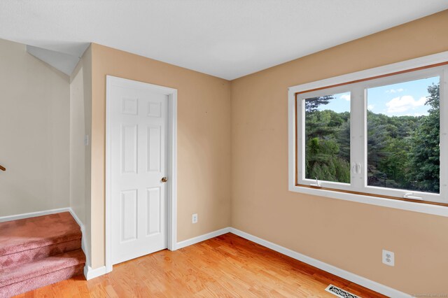 489 Wolcott St Apt 42, Bristol, CT 06010 - unfurnished bedroom featuring baseboards and light wood-type flooring