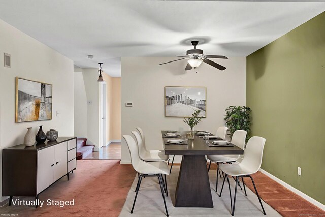 489 Wolcott St Apt 42, Bristol, CT 06010 - dining room featuring a ceiling fan, baseboards, and light carpet
