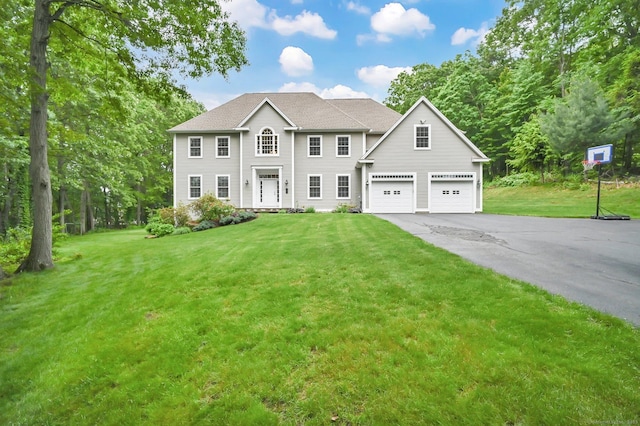 5 Jonathan Dr, Ellington, CT 06029 - colonial home with driveway, a front yard, and an attached garage