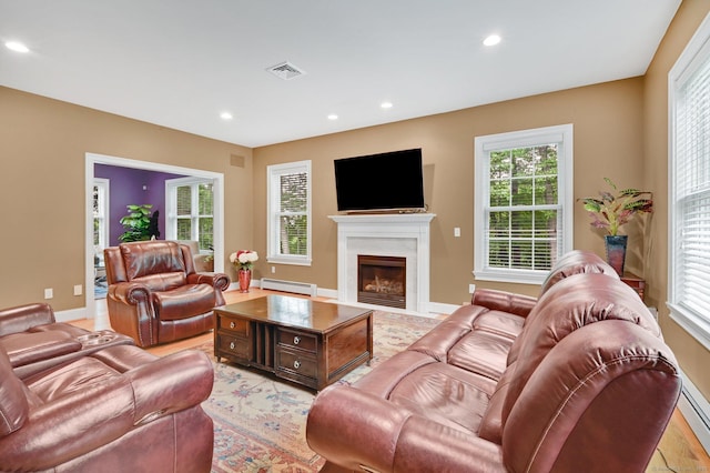 5 Jonathan Dr, Ellington, CT 06029 - living area featuring a baseboard heating unit, healthy amount of natural light, recessed lighting, a high end fireplace, and baseboards
