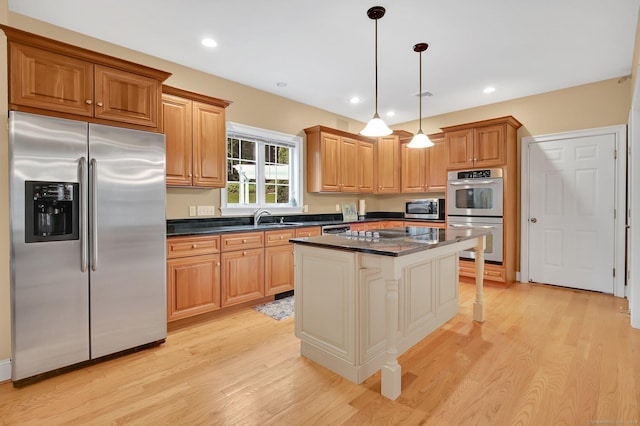 5 Jonathan Dr, Ellington, CT 06029 - kitchen featuring appliances with stainless steel finishes, dark countertops, light wood finished floors, a center island, and hanging light fixtures