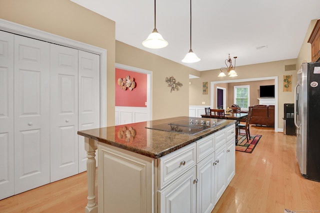 5 Jonathan Dr, Ellington, CT 06029 - kitchen featuring freestanding refrigerator, light wood-style floors, black electric cooktop, a kitchen island, and white cabinetry