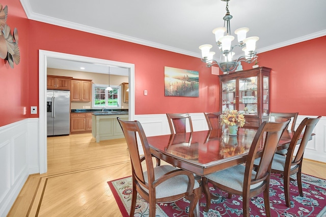 5 Jonathan Dr, Ellington, CT 06029 - dining room featuring a chandelier, ornamental molding, wainscoting, light wood-style floors, and a decorative wall