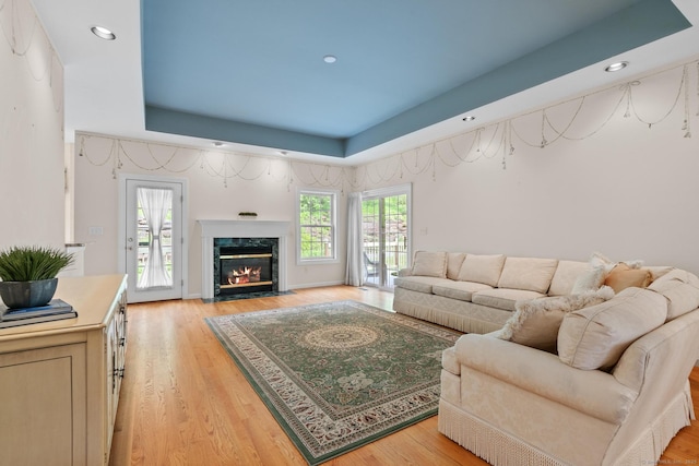 192 Rosewood Ln Unit 192, Berlin, CT 06037 - living room featuring light wood-style floors, a raised ceiling, recessed lighting, and a high end fireplace