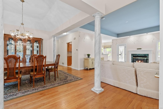 192 Rosewood Ln Unit 192, Berlin, CT 06037 - dining area with ornate columns, a chandelier, wood finished floors, baseboards, and a high end fireplace