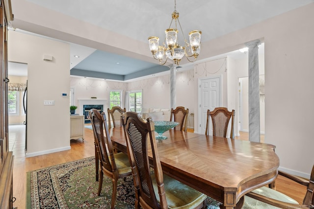 192 Rosewood Ln Unit 192, Berlin, CT 06037 - dining room with light wood-type flooring, a tray ceiling, a chandelier, and baseboards