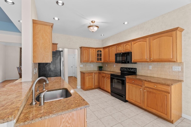 192 Rosewood Ln Unit 192, Berlin, CT 06037 - kitchen with black appliances, a sink, decorative backsplash, light stone counters, and glass insert cabinets