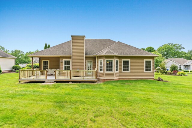 192 Rosewood Ln Unit 192, Berlin, CT 06037 - rear view of property featuring a wooden deck, a chimney, and a yard